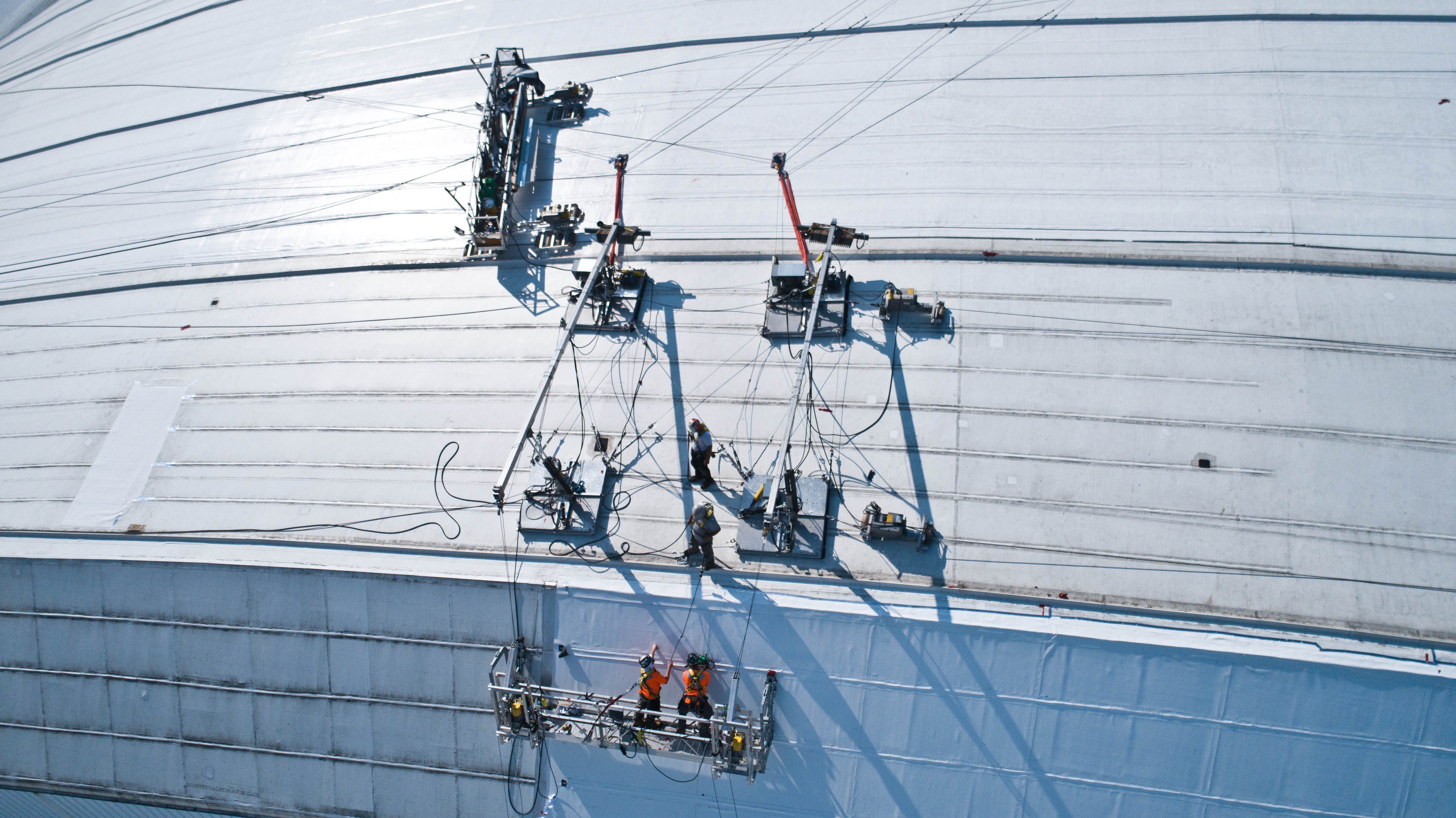 Worker reroofing Roger Center's roof